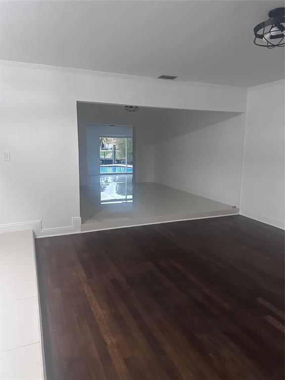 2810 Northeast 60th Street Fort Lauderdale, FL 33308 - Photo 20 of 22 a view of an empty room with wooden floor and a window