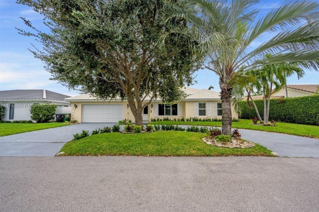 2810 Northeast 60th Street Fort Lauderdale, FL 33308 - Photo 2 of 22 a front view of a house with a yard and garage