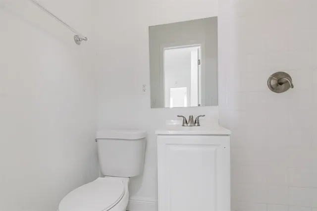 an empty room with closet and a chandelier fan