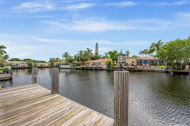 a view of a lake with boats and trees in the background