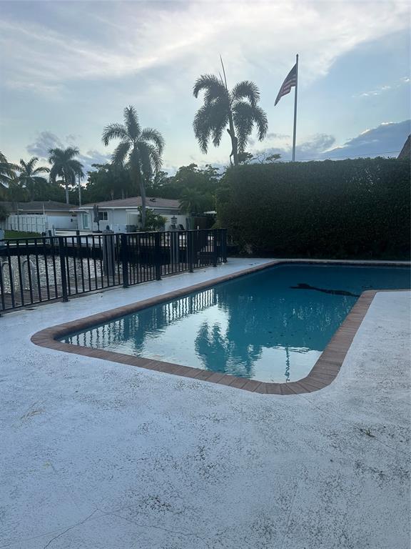 2810 Northeast 60th Street Fort Lauderdale, FL 33308 - Photo 4 of 22 a view of a swimming pool with a yard