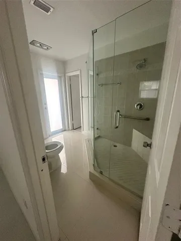 a bathroom with a tub shower and vanity