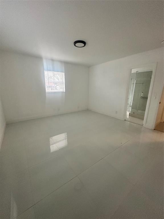 2810 Northeast 60th Street Fort Lauderdale, FL 33308 - Photo 10 of 22 an empty room with a door