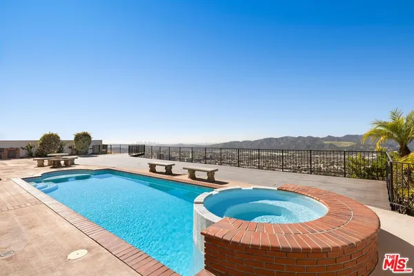 a view of a swimming pool with a lounge chair