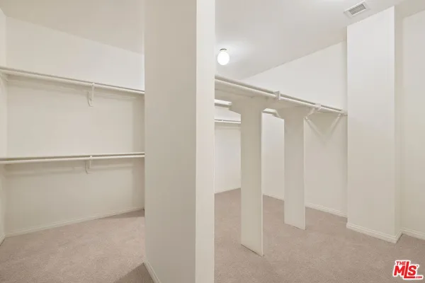 a spacious bedroom with a bed and a couch