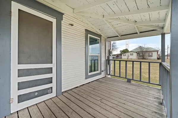 a view of a balcony with wooden floor