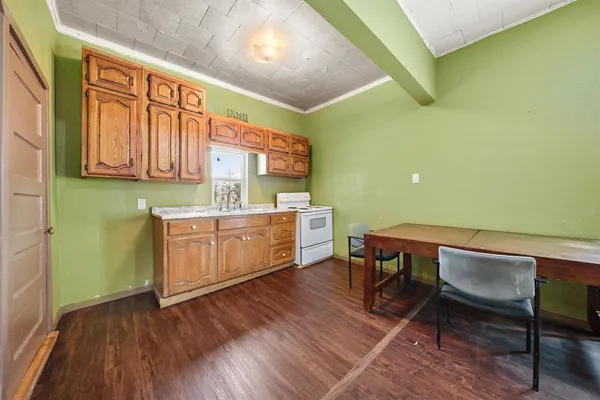 a kitchen with a wooden cabinets and chair