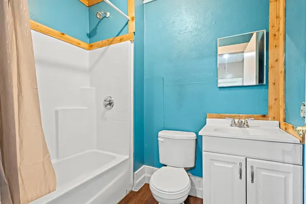 a bathroom with a sink toilet and shower
