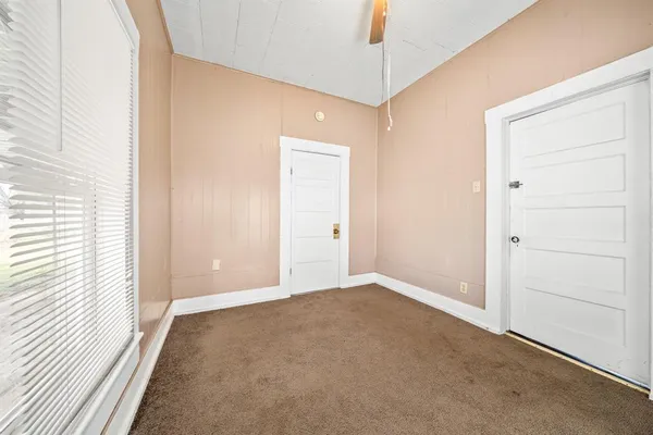 an empty room with closet and a window
