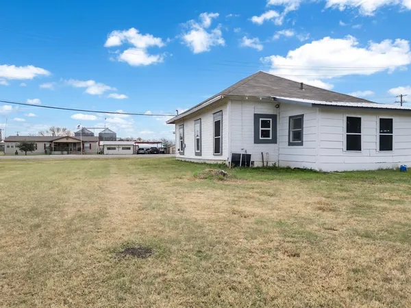 a view of a house with a backyard patio and swimming pool