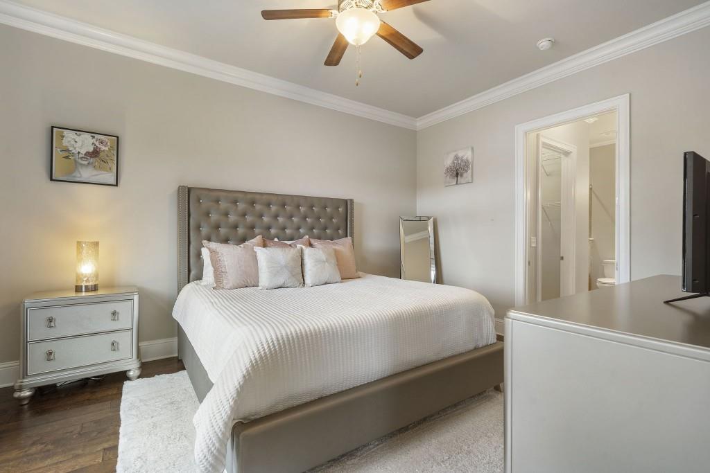 2300 Peachford Road, Unit 4403 Atlanta, GA 30338 - Photo 11 of 27 a bedroom with a bed and a chandelier