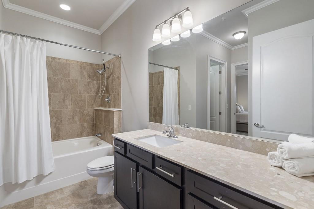 2300 Peachford Road, Unit 4403 Atlanta, GA 30338 - Photo 13 of 27 a bathroom with a granite countertop sink a toilet and shower
