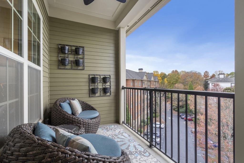 2300 Peachford Road, Unit 4403 Atlanta, GA 30338 - Photo 16 of 27 a balcony with chairs and a potted plant