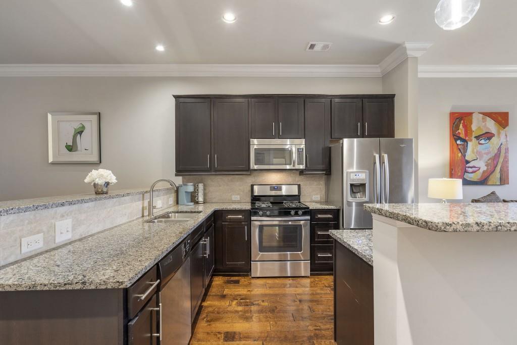 2300 Peachford Road, Unit 4403 Atlanta, GA 30338 - Photo 7 of 27 a kitchen with stainless steel appliances granite countertop a sink stove and refrigerator