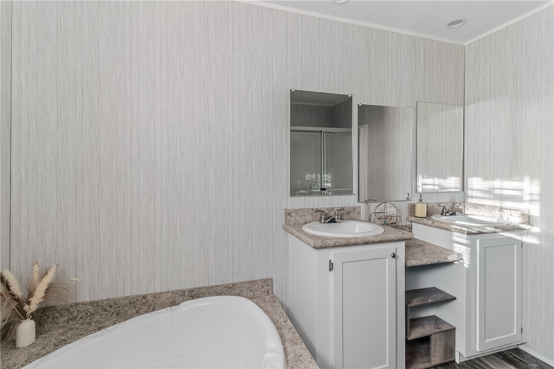 862 North Old Mill Road Easley, SC 29640 - Photo 9 of 24 This bathroom features dual vanities, a built-in tub, and a spacious shower.