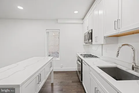 a kitchen that has a sink and a stove