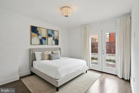 a bedroom with a large bed and a window
