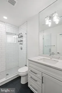 a bathroom with a toilet a sink and shower