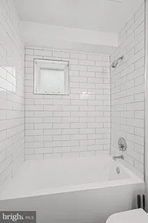 a bathroom with a bathtub and shower