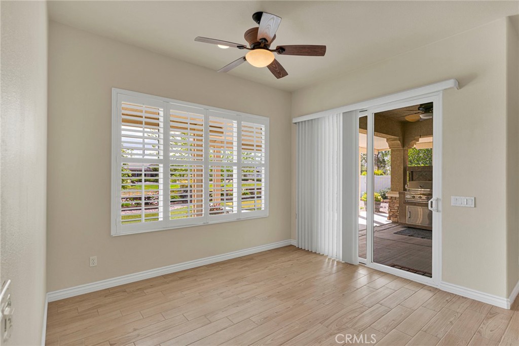 10429 Lanigan Road Apple Valley, CA 92308 - Photo 15 of 41 a view of an empty room with a window and wooden floor