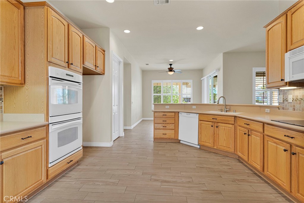 10429 Lanigan Road Apple Valley, CA 92308 - Photo 19 of 41 a large kitchen with stainless steel appliances granite countertop a refrigerator and a sink