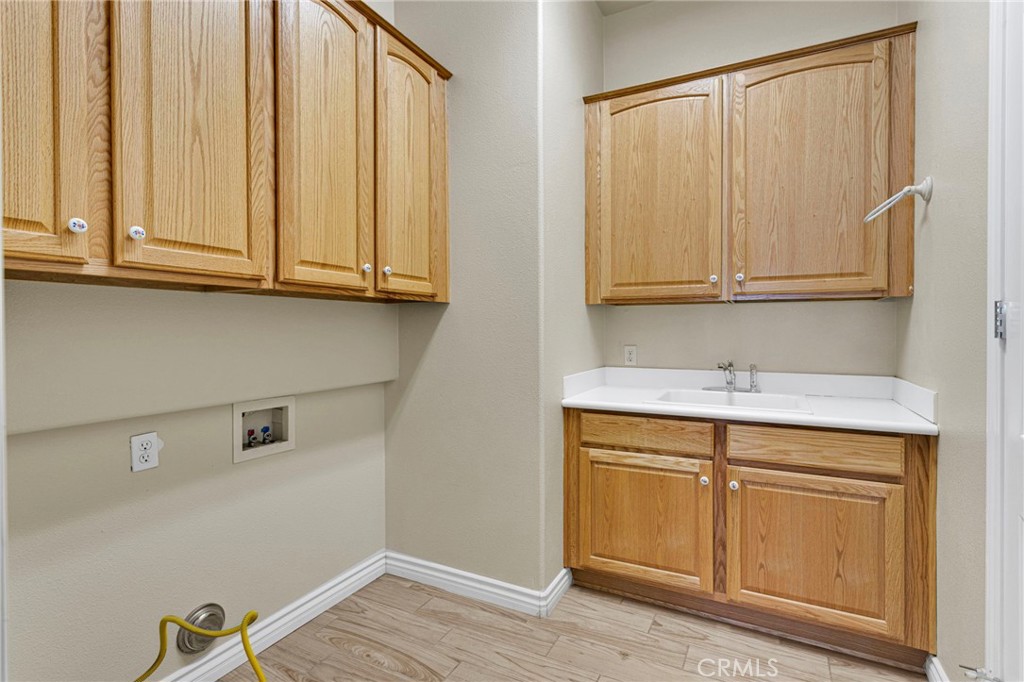10429 Lanigan Road Apple Valley, CA 92308 - Photo 22 of 41 a bathroom with a sink and cabinets