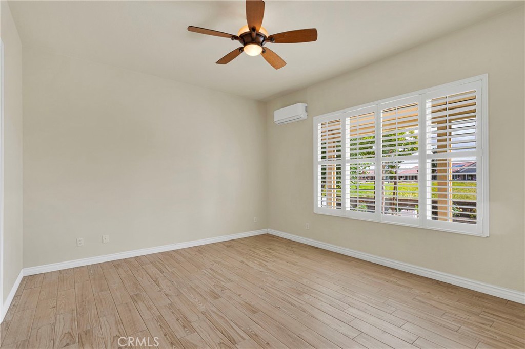 10429 Lanigan Road Apple Valley, CA 92308 - Photo 23 of 41 a view of an empty room with wooden floor and a window