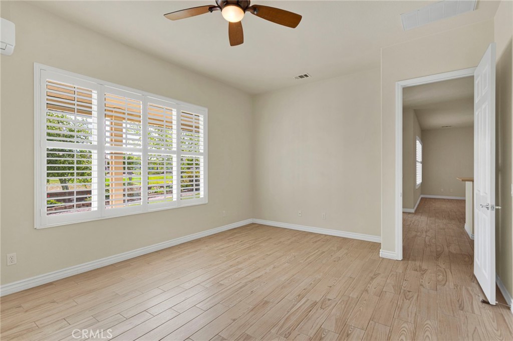 10429 Lanigan Road Apple Valley, CA 92308 - Photo 24 of 41 a view of an empty room with wooden floor and a window