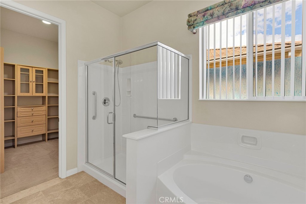 10429 Lanigan Road Apple Valley, CA 92308 - Photo 26 of 41 a bathroom with a bath tub and a shower