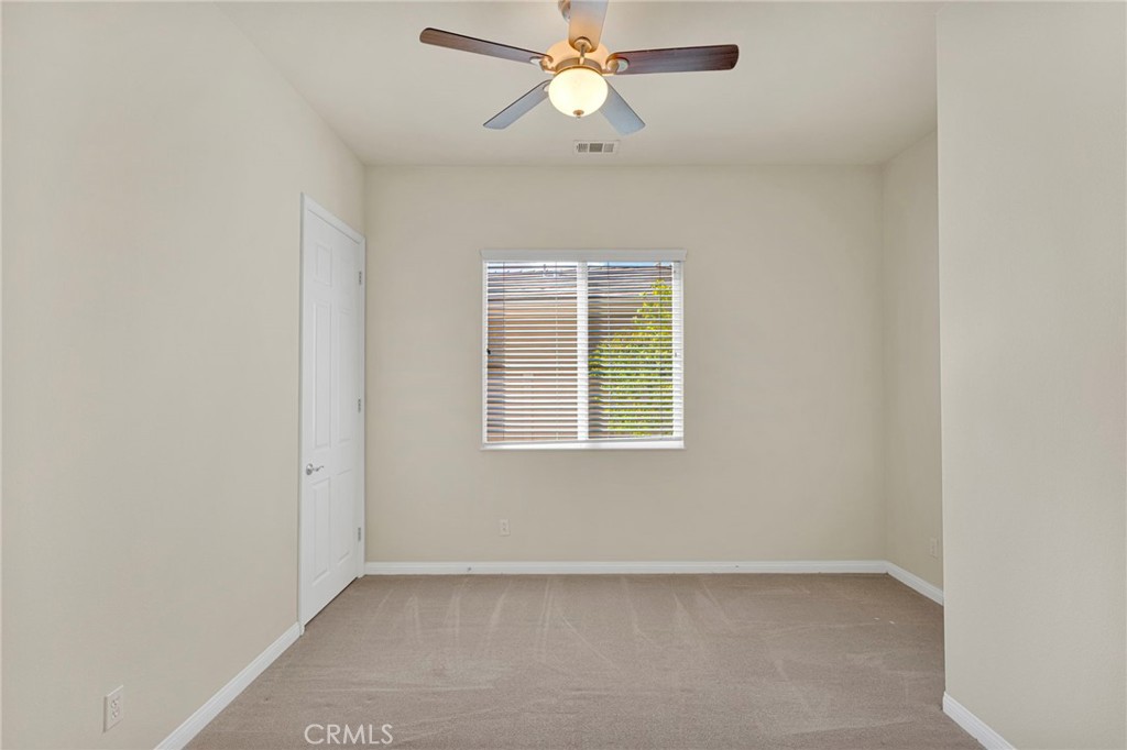 10429 Lanigan Road Apple Valley, CA 92308 - Photo 29 of 41 an empty room with a window and a fan