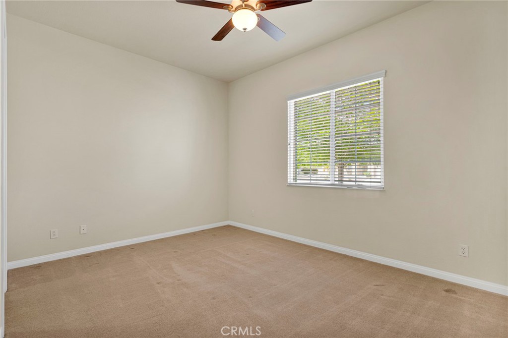 10429 Lanigan Road Apple Valley, CA 92308 - Photo 31 of 41 an empty room with a window and a fan