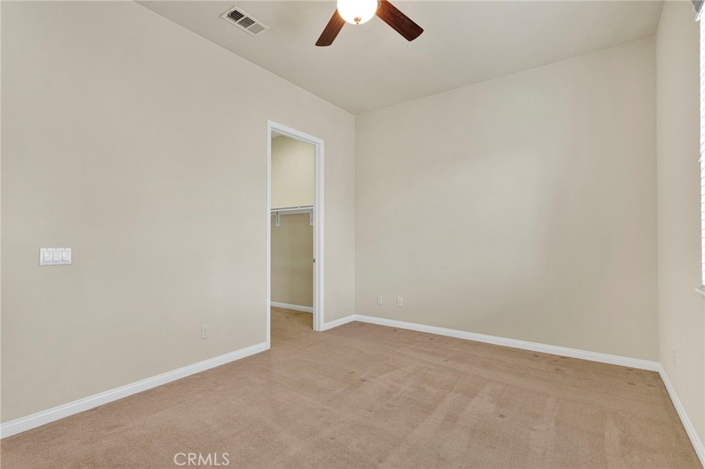 10429 Lanigan Road Apple Valley, CA 92308 - Photo 32 of 41 an empty room with a ceiling fan and window