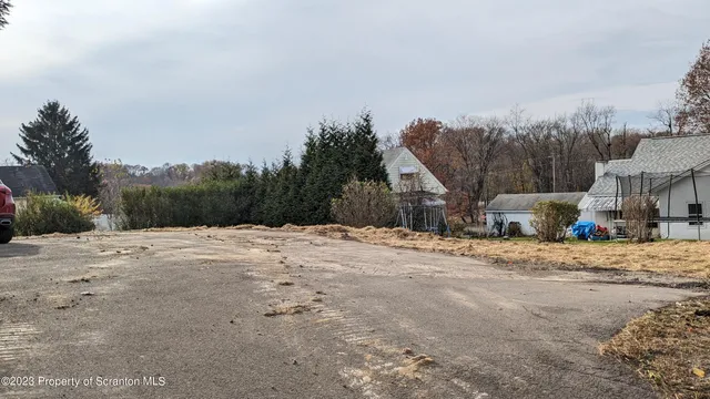a wooden bench sitting on top of a road