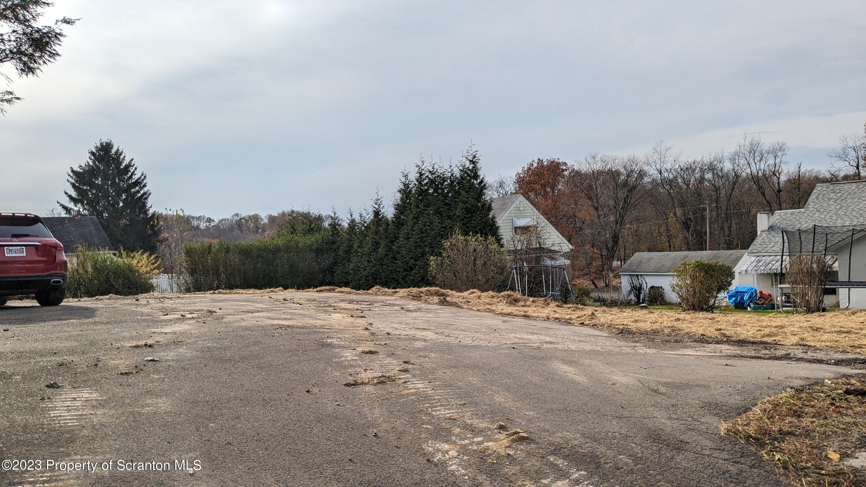 2122 Ash Street Scranton, PA 18510 - Photo 7 of 7 a wooden bench sitting on top of a road