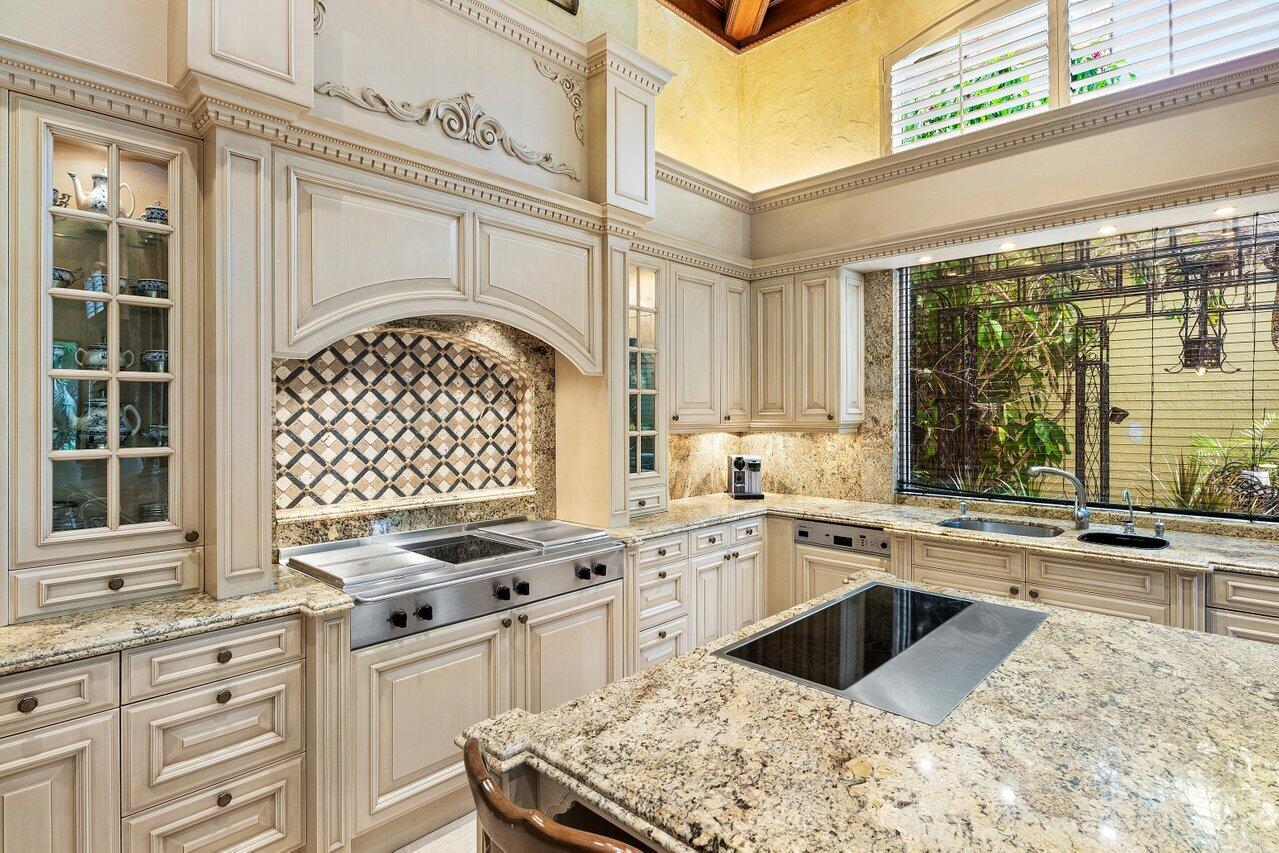 428 Addison Park Lane Boca Raton, FL 33432 - Photo 19 of 48 a kitchen with granite countertop a sink stainless steel appliances and cabinets