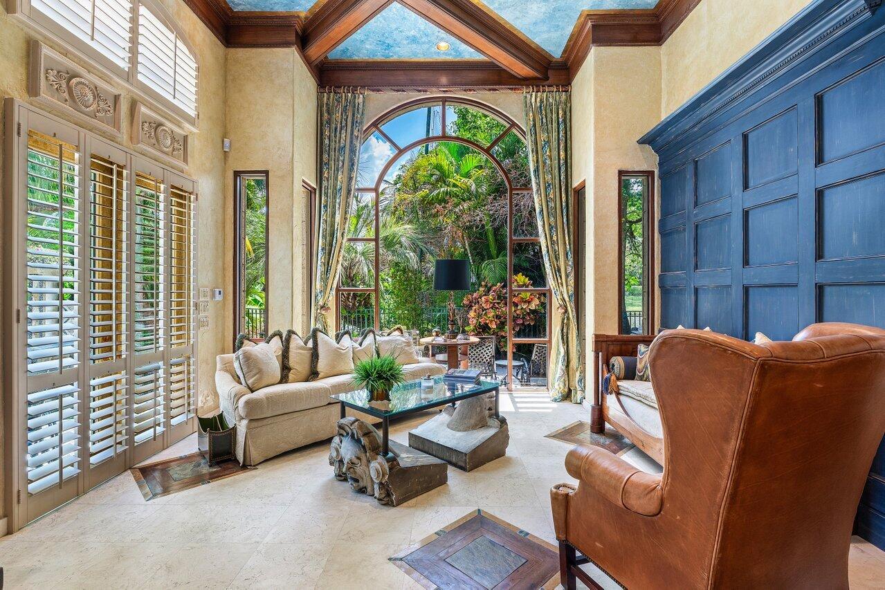 428 Addison Park Lane Boca Raton, FL 33432 - Photo 22 of 48 a living room with furniture a floor to ceiling window and potted plants