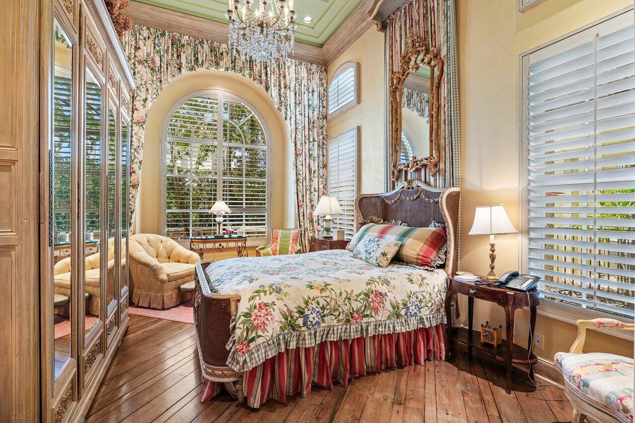 428 Addison Park Lane Boca Raton, FL 33432 - Photo 26 of 48 a bedroom with a bed and wooden floor