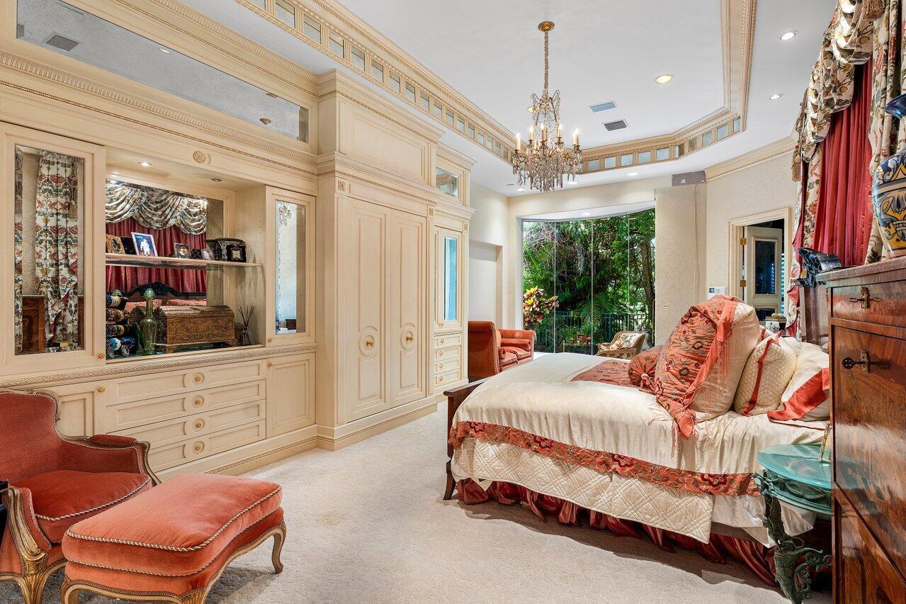 428 Addison Park Lane Boca Raton, FL 33432 - Photo 31 of 48 a bedroom with furniture and a chandelier