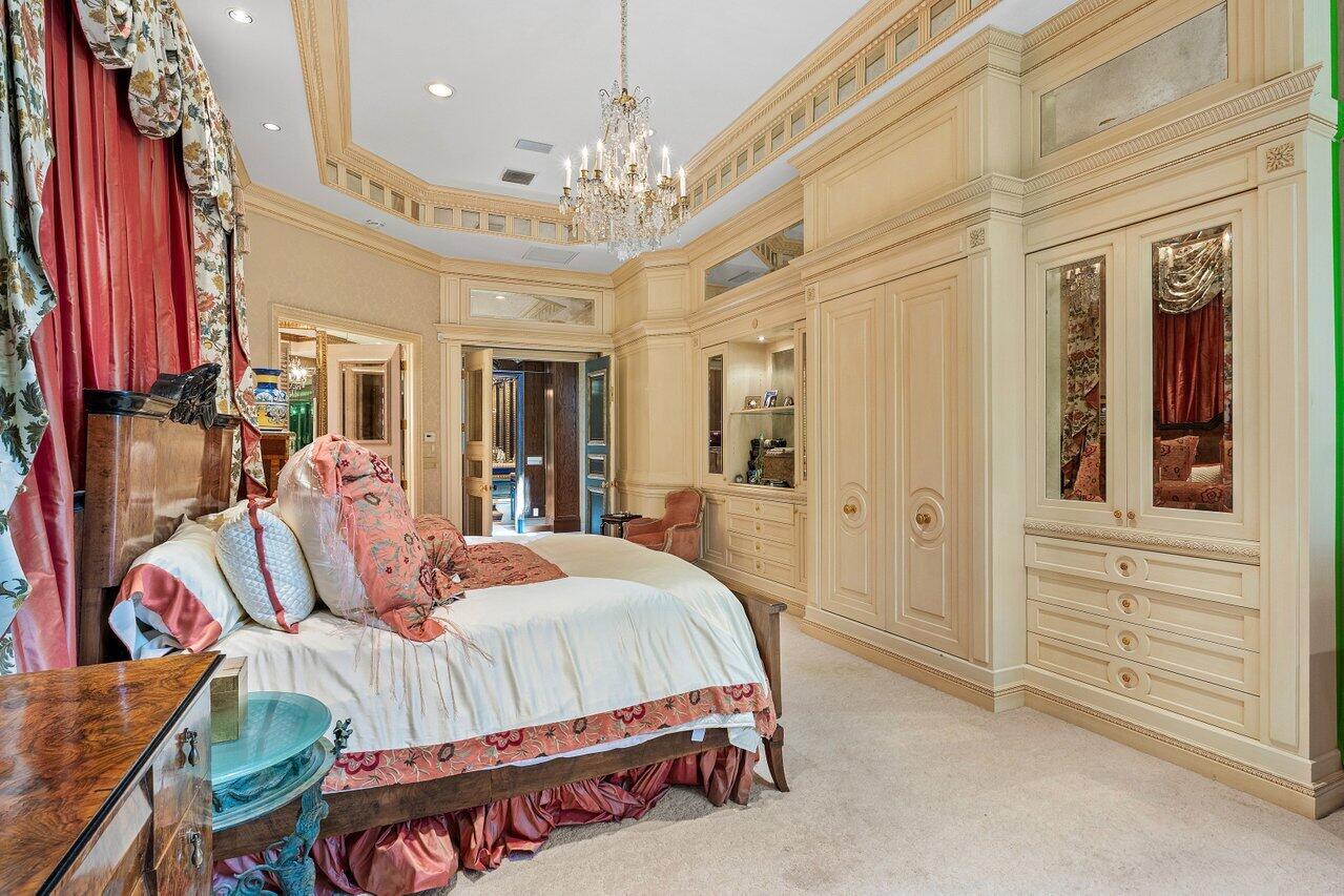 428 Addison Park Lane Boca Raton, FL 33432 - Photo 32 of 48 a bedroom with a bed and a chandelier