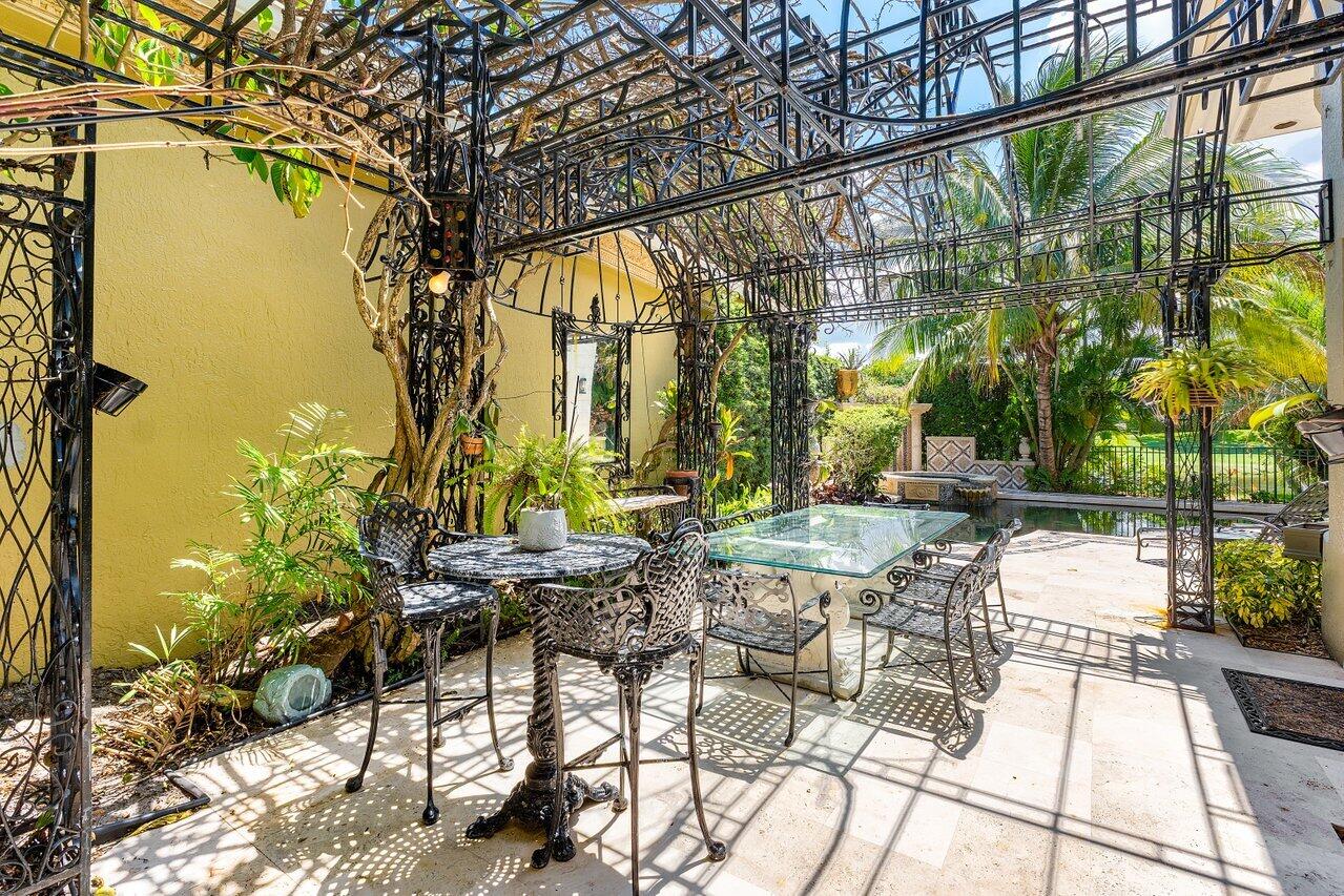 428 Addison Park Lane Boca Raton, FL 33432 - Photo 36 of 48 a view of an chairs and tables in the patio
