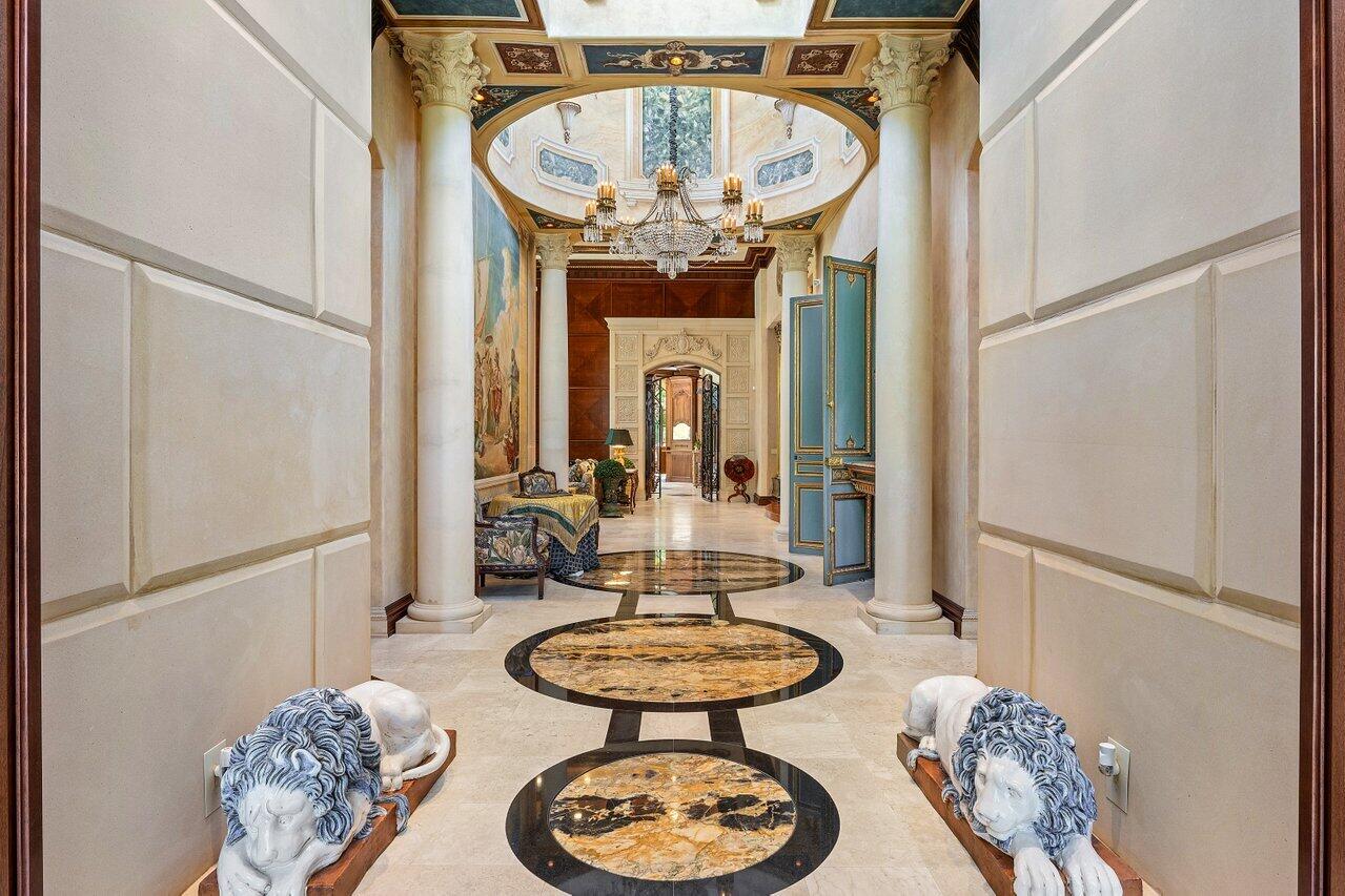 428 Addison Park Lane Boca Raton, FL 33432 - Photo 6 of 48 a view of a hallway with furniture and a chandelier