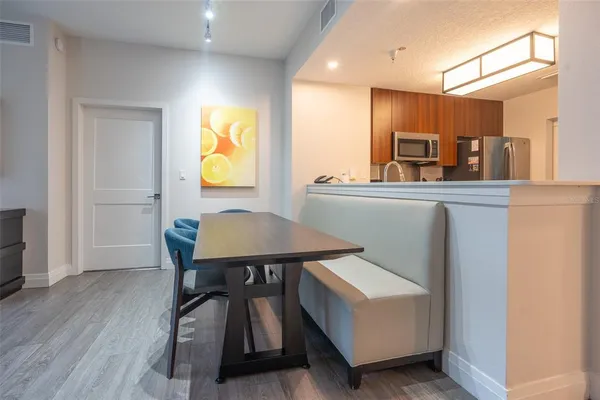 a view of kitchen with furniture and wooden floor