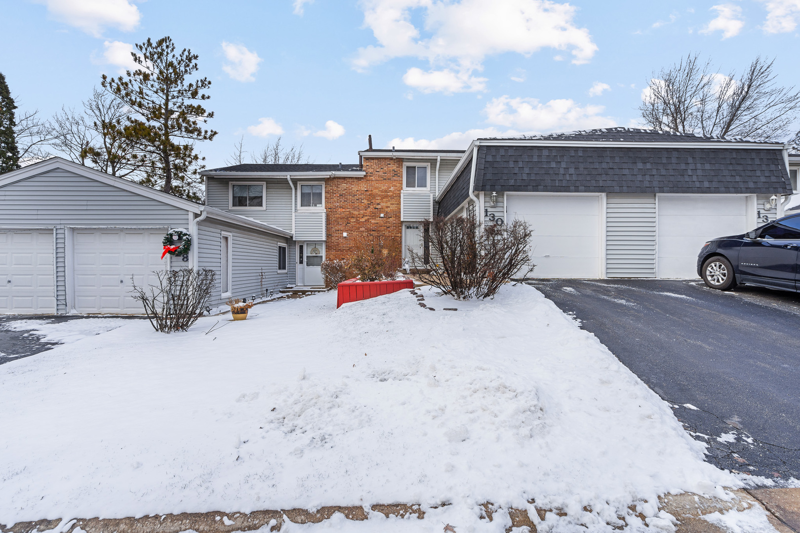 a view of a house with snow ground and a garage