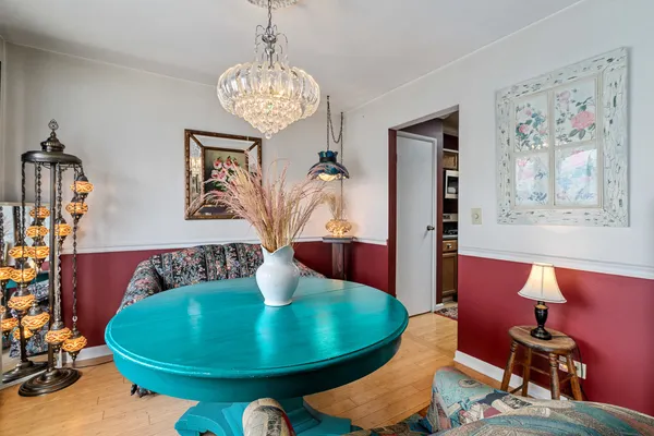 a view of a dining room with furniture wooden floor and a chandelier