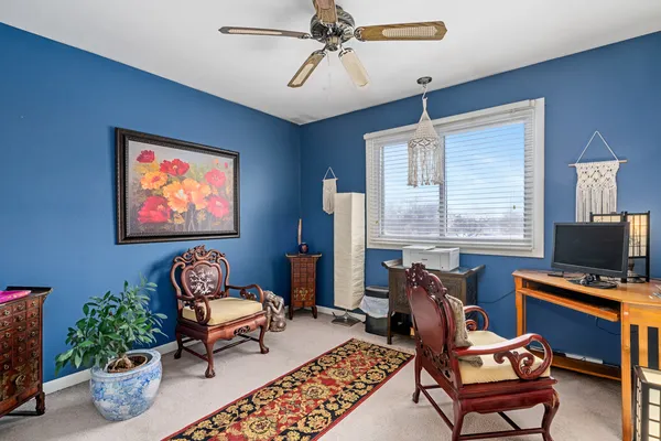 a living room with furniture a piano and a flat screen tv