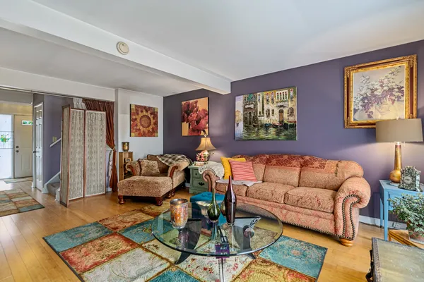 a living room with furniture a rug and a window