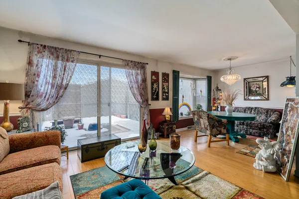 a living room with fireplace furniture and a large window
