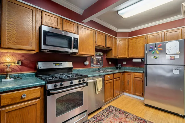 a kitchen with stainless steel appliances granite countertop a stove a sink and a microwave
