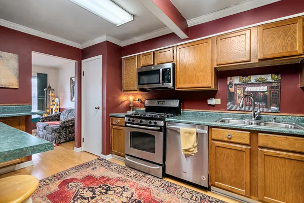 a kitchen with stainless steel appliances granite countertop a stove and cabinets