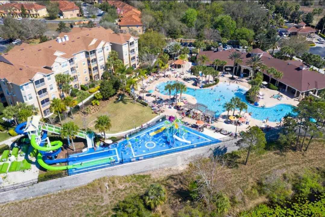 2784 Almaton Loop, Unit 301 Kissimmee, FL 34747 - Photo 15 of 37 an aerial view of a house with a yard and lake